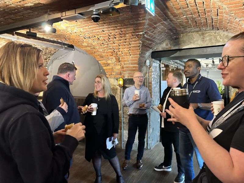 group of people in coworking space at coffee networking event