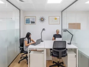 a flexible office space with 2 people in it