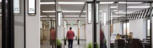 man in corridor kings house business centre 300x94